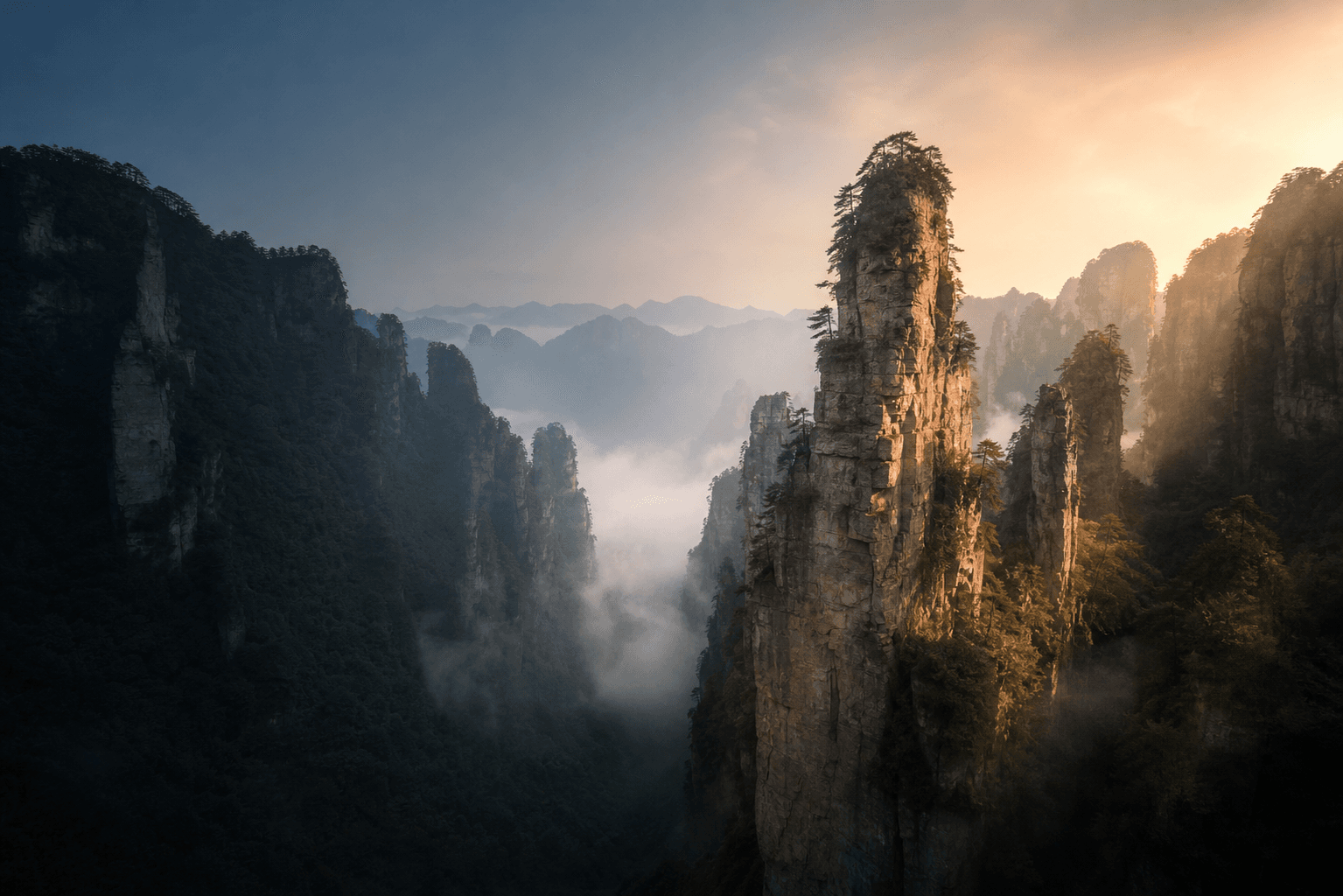 Misty sandstone pillar mountains in Zhangjiajie at sunrise